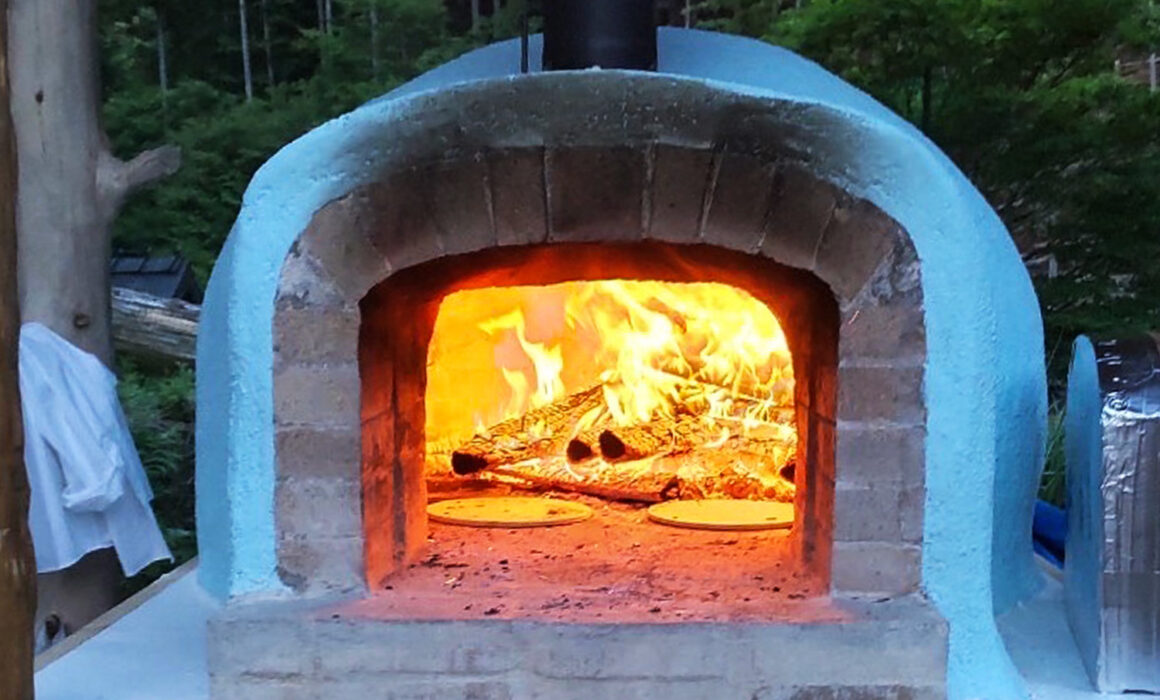 Brick pizza oven in the evening-front