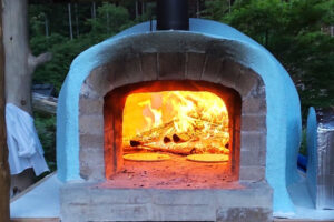 Brick pizza oven in the evening-front