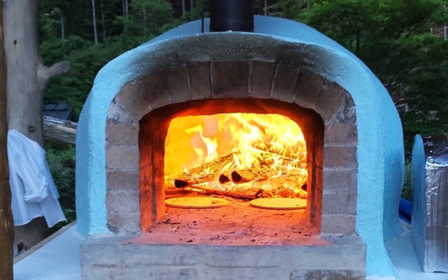 Brick pizza oven in the evening-front